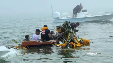 In this image provided by Sky Decker Jr., authorities and volunteers respond to a Mexican Navy plane crash near Galveston, Texas, Monday, Dec. 22, 2025