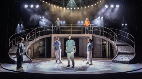 Nottingham Playhouse/Marc Brenner Julie watches as the actor David Shields plays the part of Jacob at the centre of the stage 