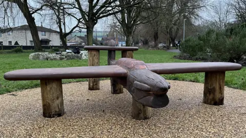 The aircraft bench, which is carved out of wood, in situ at the gardens.