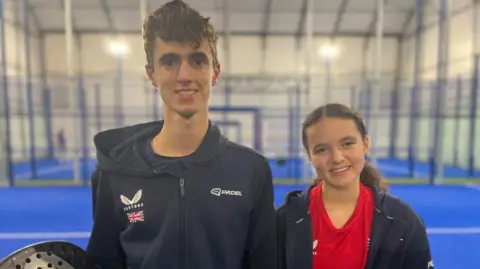 Liam and Chloe De La Mare with rackets in hand