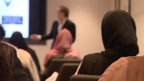 Young people looking at a screen