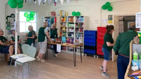Alton Foodbank Volunteers gathered around inside the foodbank