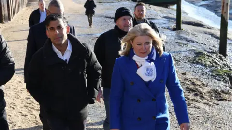 BBC Anna Firth and Rishi Sunak walking along Leigh seafront