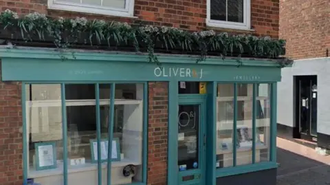 Exterior of a shop which is painted a turquoise blue.