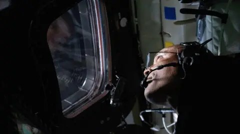 NASA  Victor Glover looks out of the window of the Orion spacecraft 