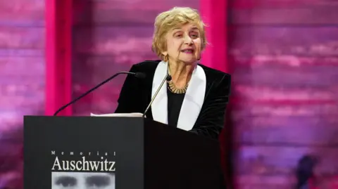 Holocaust survivor Tova Friedman delivers a speech at a ceremony commemorating the 80th anniversary of liberation of the former German Nazi concentration