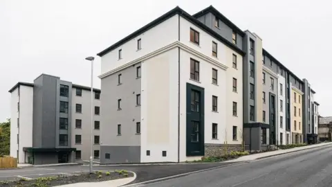 DOUGLAS COUNCIL The exterior of two modern blocks of flats, which are coloured white, grey and beige on Peel Road.