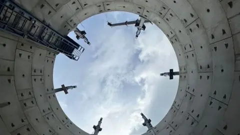 View from the bottom of a storm overflow storage tank looking up to open sky. 