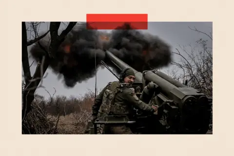 Reuters A Ukrainian soldier fires a self-propelled howitzer at Russian troops. He looks away as it fires black smoke into the sky