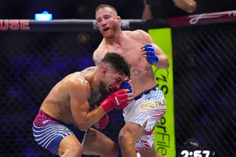 Getty Images Justin Gaethje strikes Ilia Topuria in the face during a UFC fight held at the White House