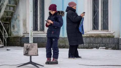Reuters Local residents use a Starlink terminal, amid Russia's attack on Ukraine, in Chasiv Yar, Donetsk region, Ukraine January 31, 2023