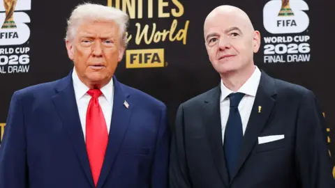 US President Doanld Trump and Fifa president Gianni Infantino stand next to each other