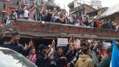 Getty Images Supporters react upon seeing Prime ministerial candidate Balen Shah of the Rastriya Swatantra Party