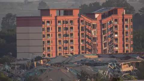 BBC/ Jonathan Head A damaged building inside KK Park as seen from across the Thai-Myanmar border. 