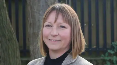 Labour Emma Roberts with medium-length brown hair and grey jacket