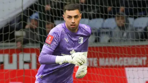 Wyll Stanway wearing a purple Barrow goalkeeper kit