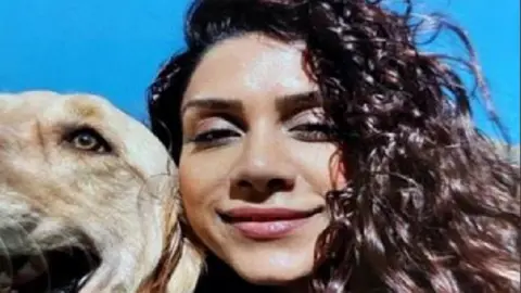 Close up image of smiling woman and her dog