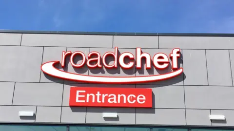 Getty Images Front view of a red and white Roadchef sign. An additional sign that reads "Entrance" is mounted below.