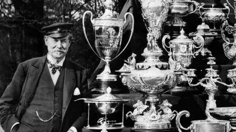 man with lots of trophies