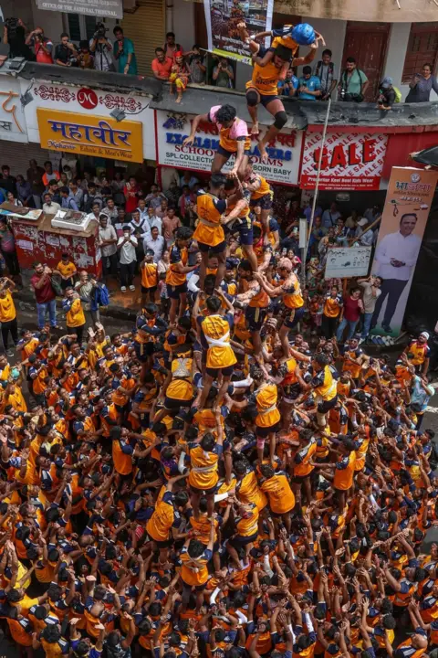 Divyakant Solanki / EPA-EFE Indian devotees form a human pyramid in Mumbai