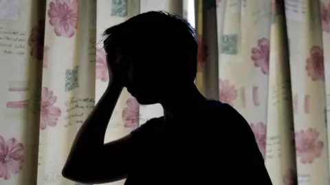  Niall Carson/PA Wire Woman silhouette