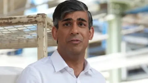 PA Media Prime Minister Rishi Sunak talking to staff during his visit to Denby Pottery Factory