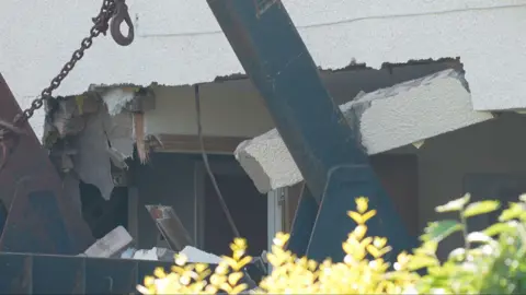 The damaged wall of a home after a lorry went through the exterior wall