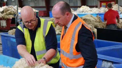 SOSE Two men checking a fleece in Selkirk