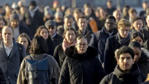 Commuters cross London Bridge in London, UK, on Monday, Feb. 17, 2025.