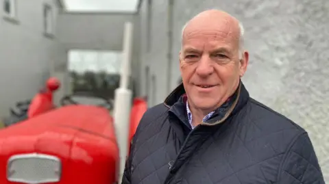 A man in a barbour coat 