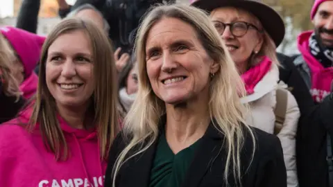 Getty Images Kim Leadbeater standing alongside campaigners wearing pink outside Parliament