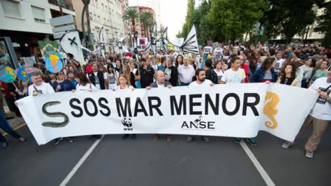 Getty Imgaes Demonstrators are seen with a banner ‘S.O.S Mar Menor’ during the concentration in Cartagena on October 30, 2019 in Murcia, Spain.