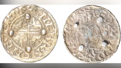 Colchester and Ipswich Museum Service Edward the Confessor coin brooch. Both sides are shown with the front depicting a cross with birds in each quarter and the back showing four blobs, where the pin and fastening would once have been 