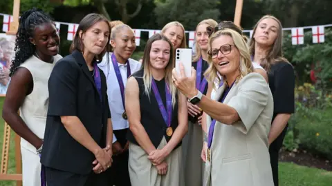 Getty Images England's head coach Sarina Wiegman poses for a selfie with her players during a reception at Downing Street in central London on 28 July 2025, after winning the Women's Euro 2025.
