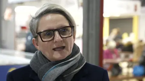 Conservative candidate Charlotte Cadden, wearing black rimmed glasses and a scarf round her neck