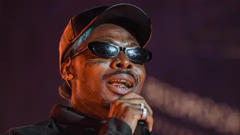 Asake  with dark shades hold microphone and performs onstage during AfroFuture Festival at Bedrock's Douglass Site on 16 August 2025 in Detroit, Michigan