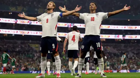 Getty Images Jude Bellingham celebrates with teammate Harry Kane after scoring his team's first goal during the FIFA World Cup 2026 Round of 16 match between Mexico and England at Estadio Azteca in Mexico City.