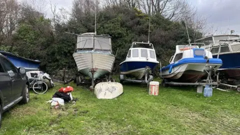 Boats lined up in Netpool Boat Yard in  Cardigan, 