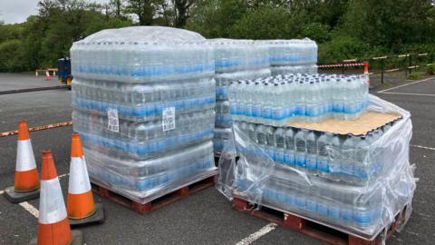 Crate of bottled water in Devon car park