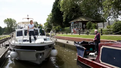 Two cruise boats in a lock on River Thames.
