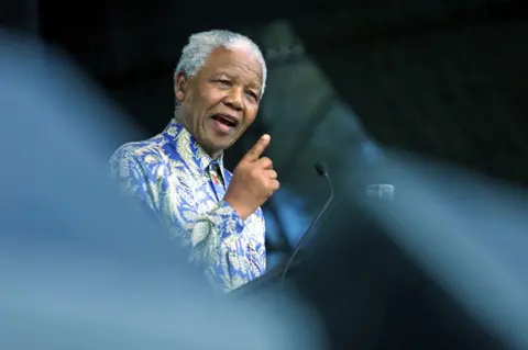 Nelson Mandela giving a speech at a podium