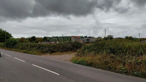 Daniel Mumby A view from the road of the farmland on a very overcast day.