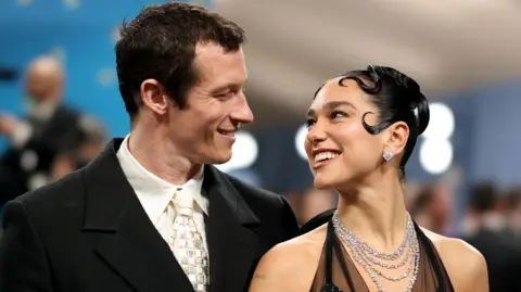 Getty Images English actor Callum Turner alongside his fiancé, pop star Dua Lipa