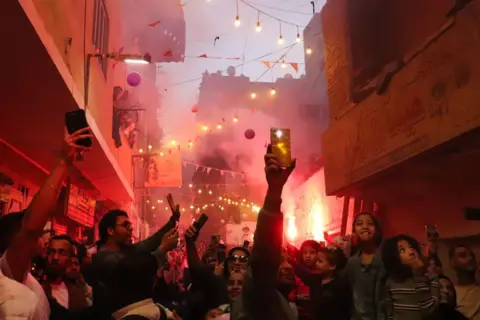 Ahmed Mosaad / Getty Images Celebrations take place after a communal iftar in the Matariya district of Cairo, Egypt. (Photo by Ahmed Mosaad/NurPhoto via Getty Images) 15 March