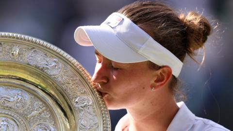 Barbora Krejcikova kisses the Wimbledon trophy