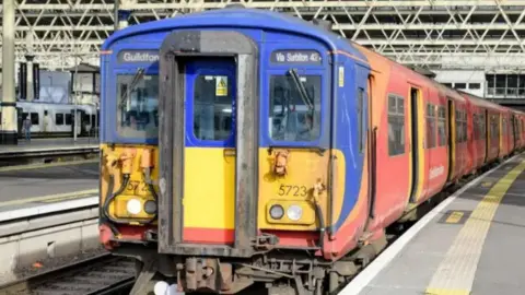 South Western Railway A red Class 455 South Western Railway train with a yellow front.
