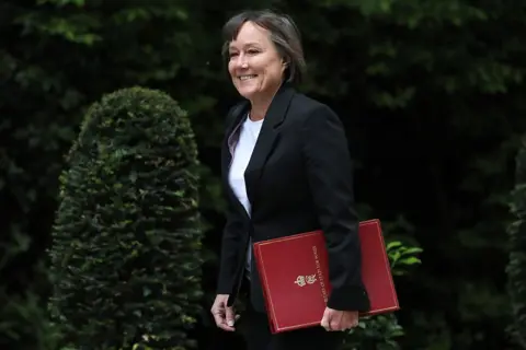Getty Images Welsh Secretary Jo Stevens carrying a red folder