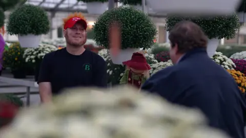 Greg Smith sat opposite the BBC's Gary O'Donoghue in Greg's garden centre