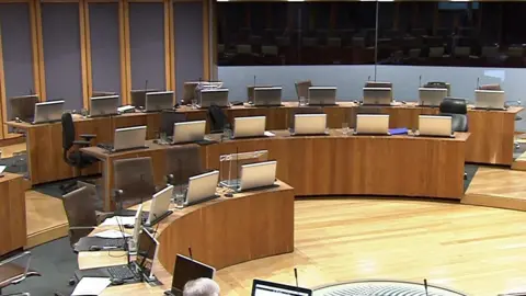 Senedd Cymru A shot of empty chairs on one side of the Senedd, where the Conservatives are usually sat.