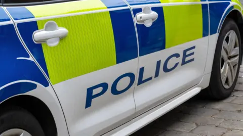 A stock image of the side of a police car